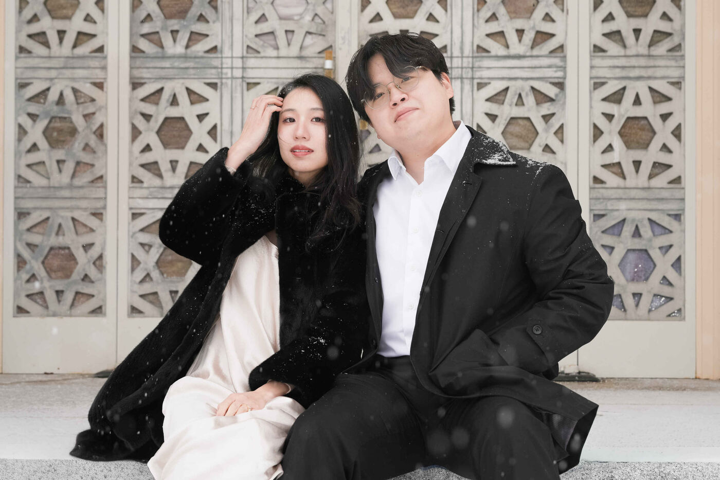 A couple together in falling snow